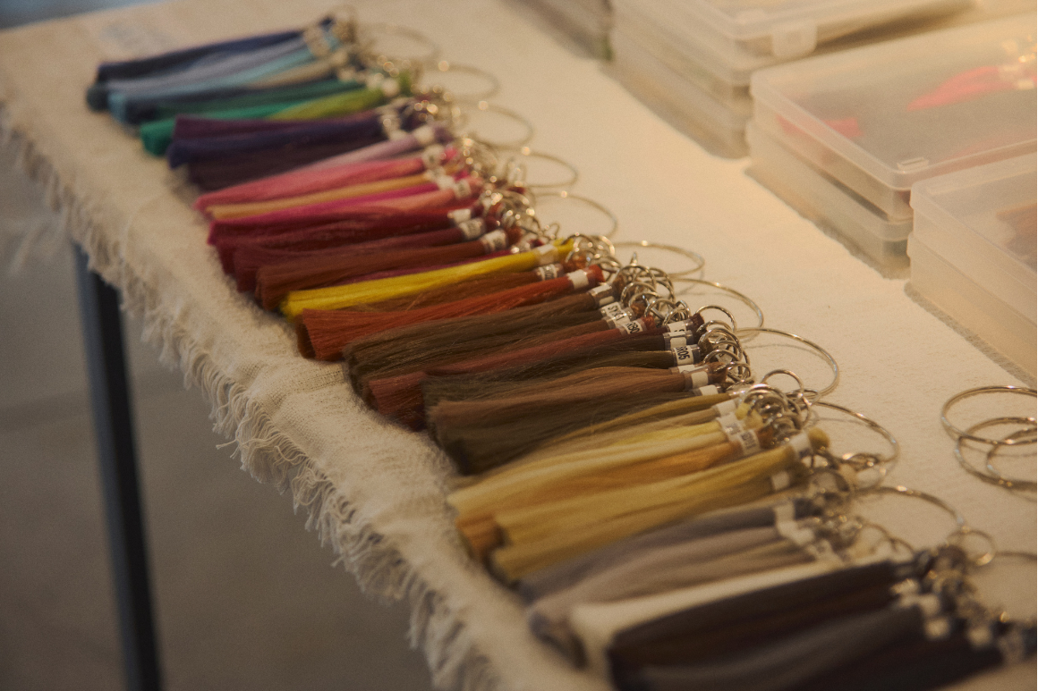 Color sample tassels laid out in a graded row for choosing a direction